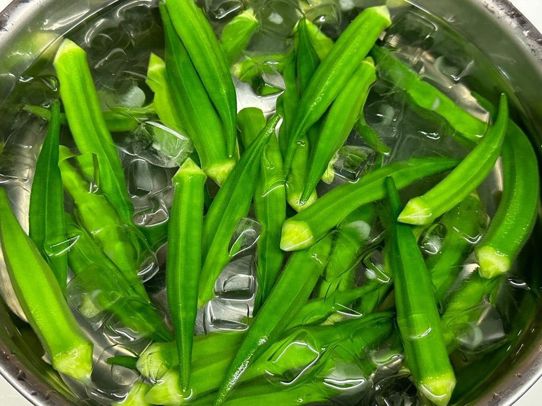 Morning-picked okra, chilled in ice water